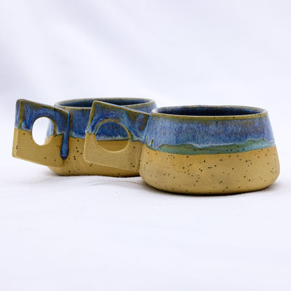 Bluverde Formo handmade ceramic stoneware coffee mug by Ribera Handmade Ceramics, showcasing a textured blue and earthy-toned finish.