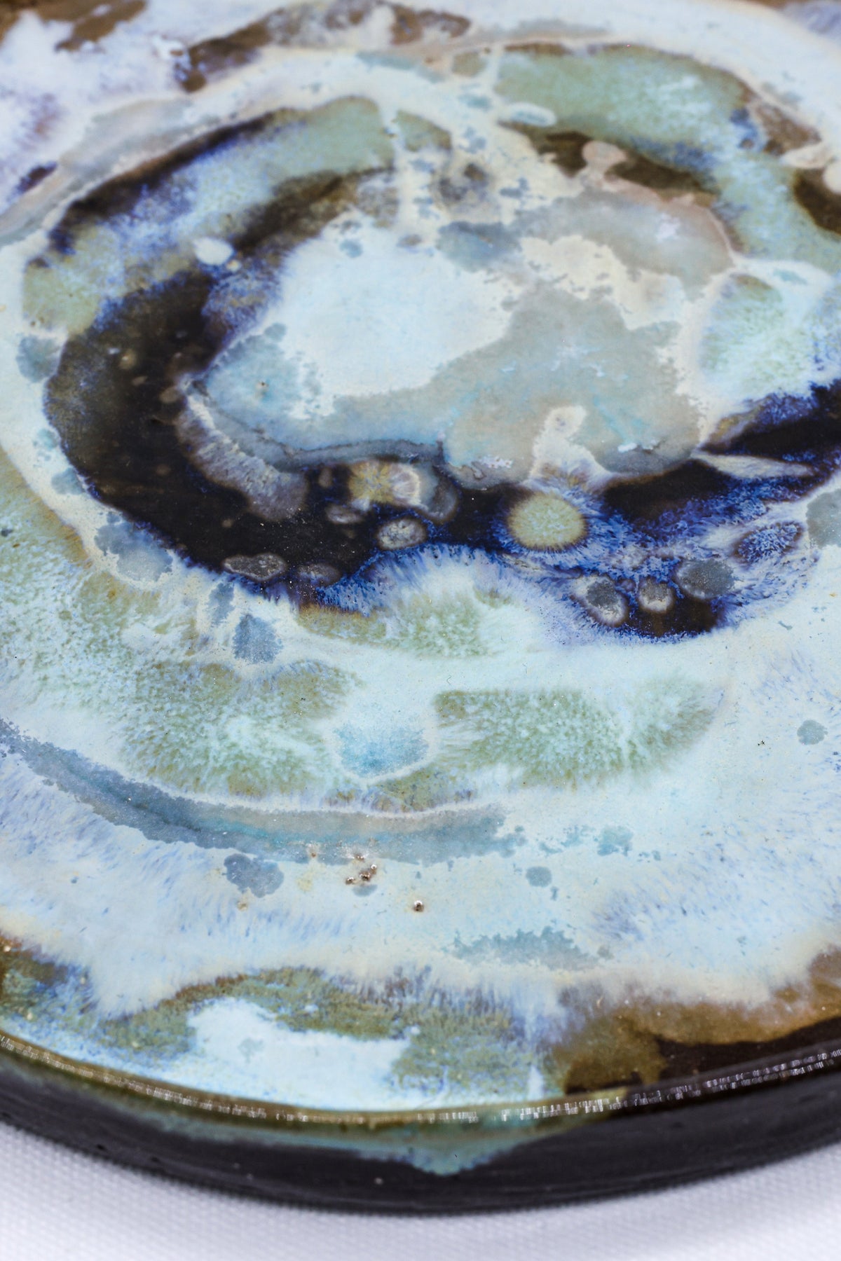 Large 23 cm Coralight smoked grey stoneware dinner plate by Ribera Handmade Ceramics, showcasing its textured ceramic surface.
