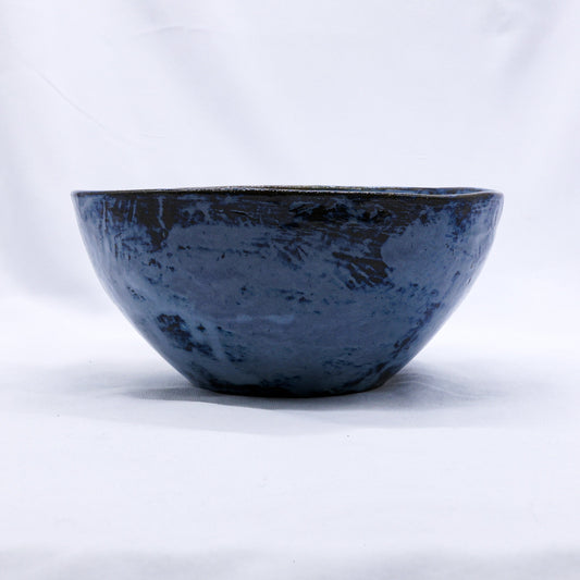 Small smoked grey and tidal blue handmade ceramic stoneware dinner bowl by Ribera Handmade Ceramics, showcasing its textured glaze and shape.