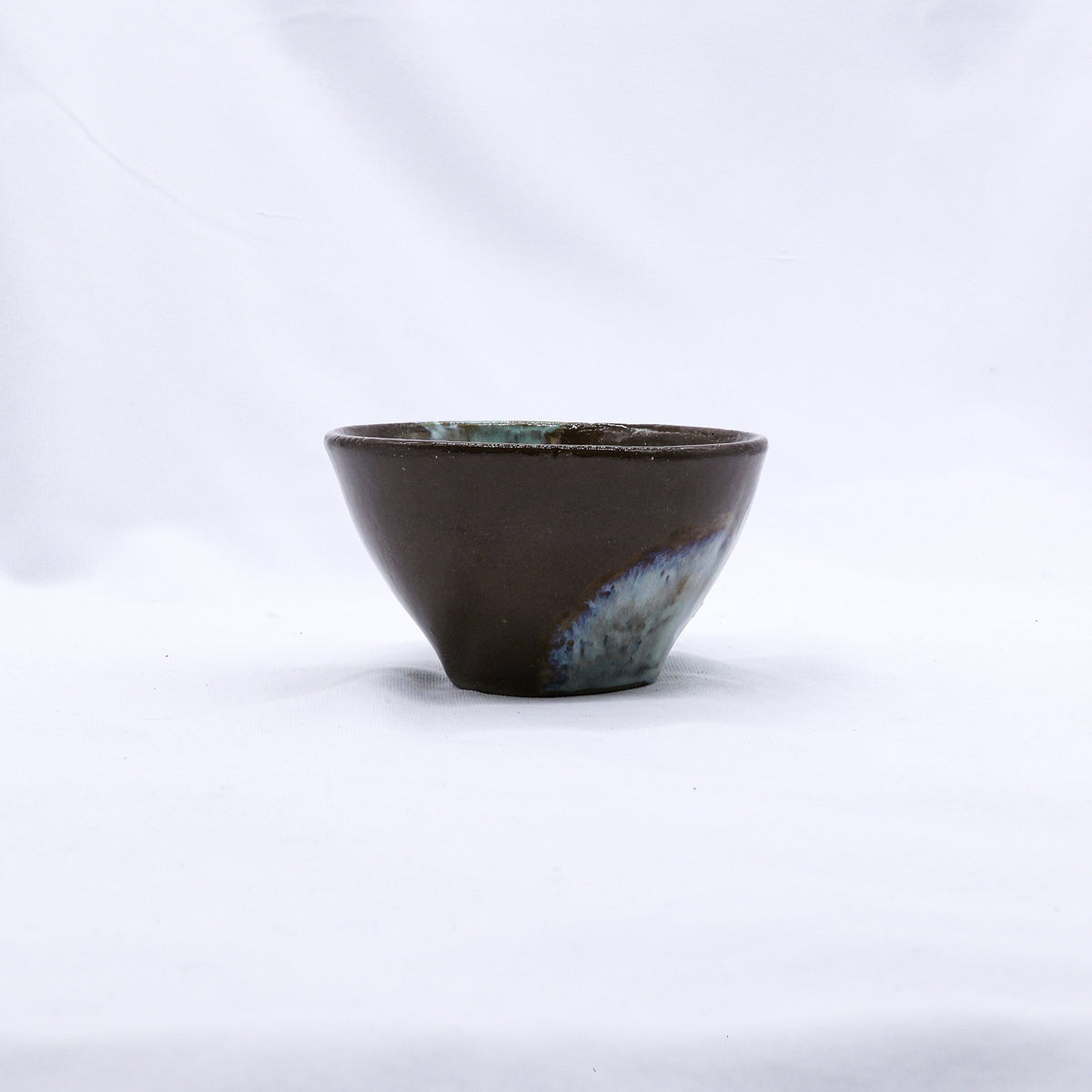 Blue handmade ceramic dinner bowl featuring a small stone reef design by Ribera Handmade Ceramics.