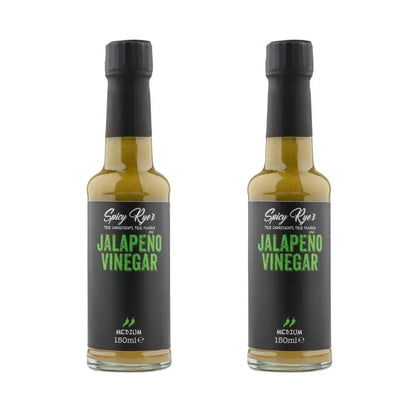 Two bottles of Spicy Ryes Jalapeño Vinegar with green jalapeño peppers in clear glass bottles on a white background.