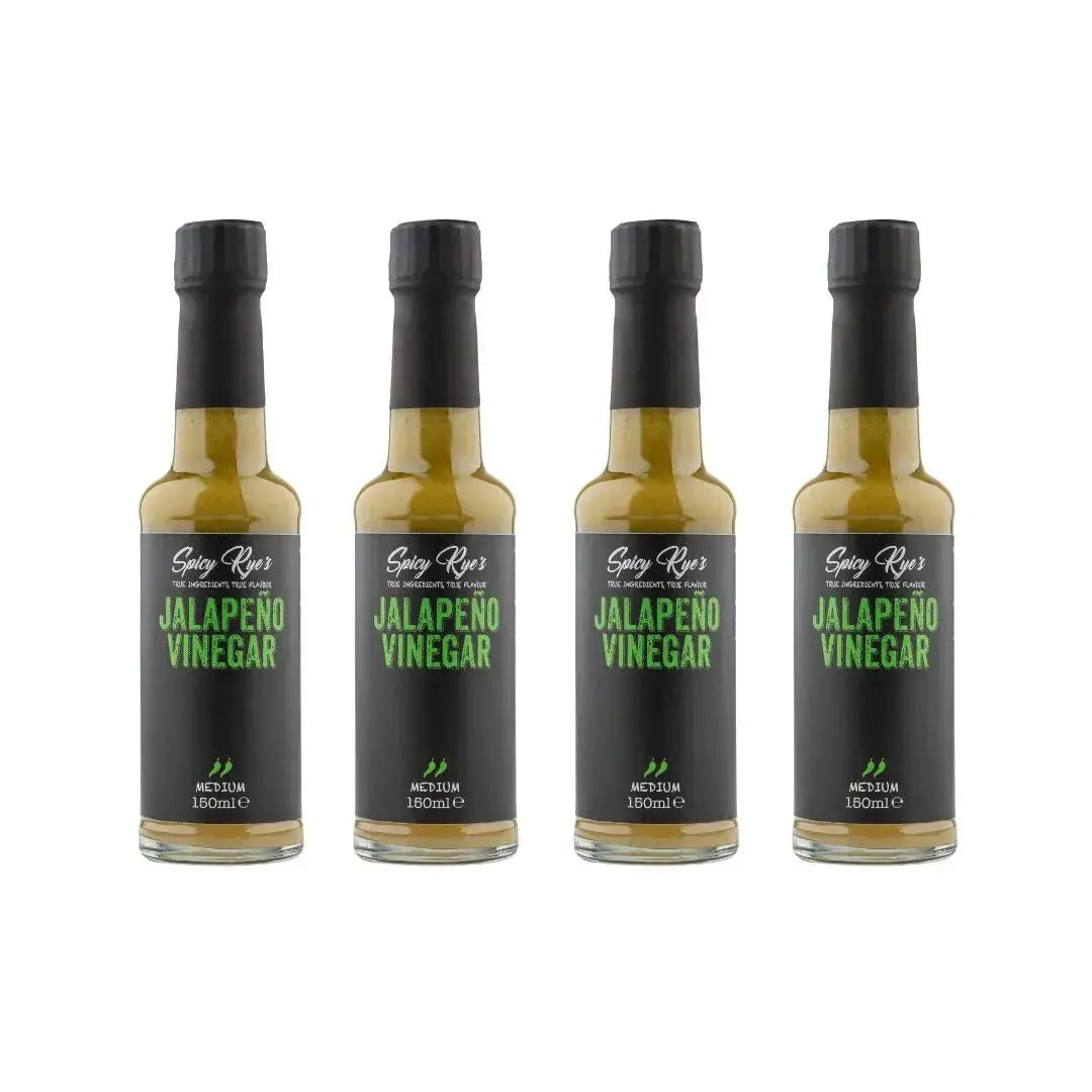 Four bottles of Spicy Ryes jalapeño vinegar showing vibrant green jalapeño peppers and clear vinegar in glass bottles.