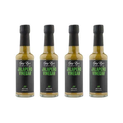 Four bottles of Spicy Ryes jalapeño vinegar showing vibrant green jalapeño peppers and clear vinegar in glass bottles.