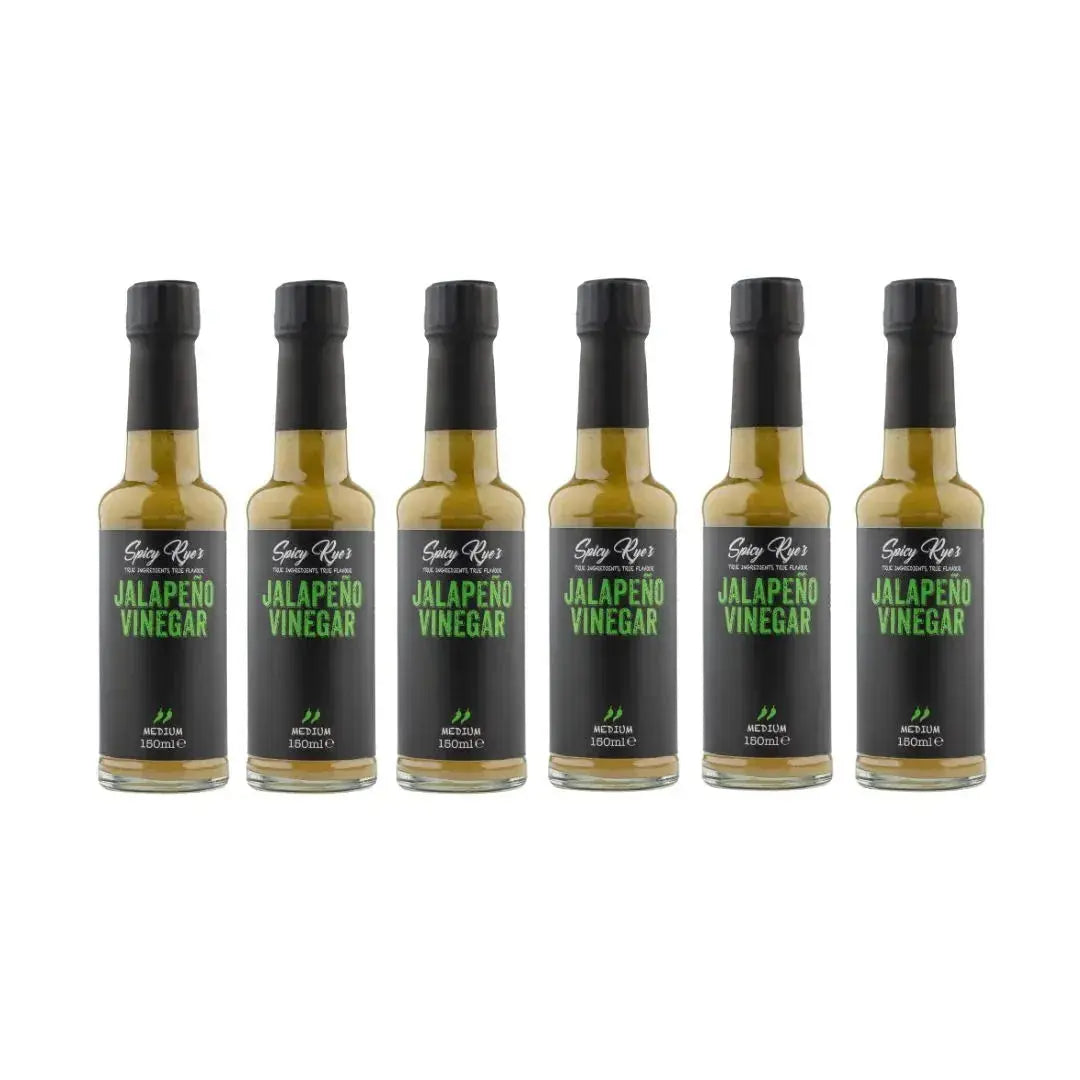 Six bottles of Spicy Ryes Jalapeño Vinegar with vibrant green jalapeño peppers on the labels, arranged in a group.