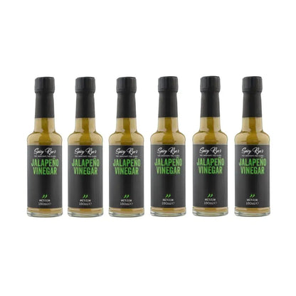Six bottles of Spicy Ryes Jalapeño Vinegar with vibrant green jalapeño peppers on the labels, arranged in a group.