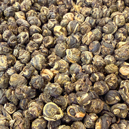 Loose green tea pearls from Porter Hill Tea Company, Jasmine Dragon Pearls with fresh jasmine aroma and vibrant green leaves.