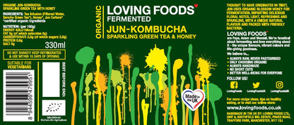Assorted bottles of Loving Foods Organic Jun-Kombucha in a mixed case, showcasing colorful labels and glass bottles on a white background.