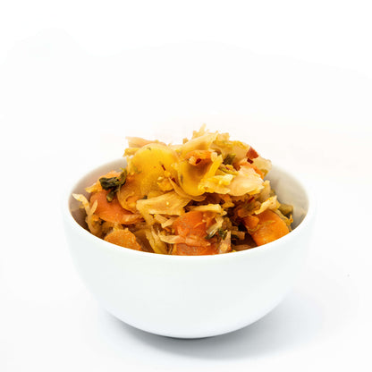 Organic Kimchi by Loving Foods in a glass jar showing vibrant fermented vegetables and spicy seasonings.