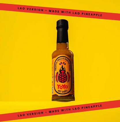 Signature Lao Pineapple Hot Sauce by YoYo Laos Sauce, featuring a vibrant pineapple-flavored hot sauce in a clear bottle.
