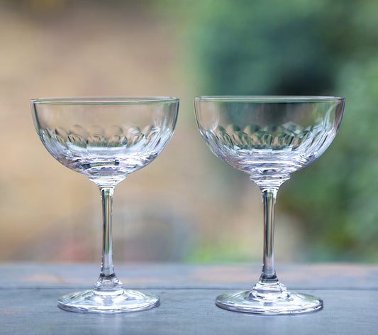 Large crystal champagne saucers with elegant lens design, showcasing clear glass and sophisticated style from The Vintage List.