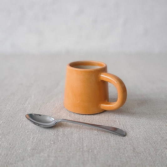 Mandarin orange espresso mug by Katie L Thompson Designs with a classic shape and vibrant citrus color.