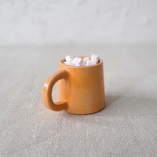 Mandarin orange ceramic espresso mug by Katie L Thompson Designs with a classic shape and vibrant color.
