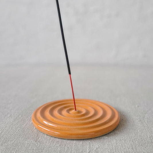Mandarin orange ceramic incense burner by Katie L Thompson Designs with intricate patterns and a round shape.
