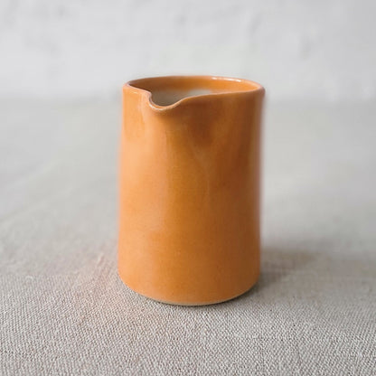 Small ceramic jug with a Mandarin Orange design by Katie L Thompson Designs, featuring a classic shape and vibrant orange pattern.
