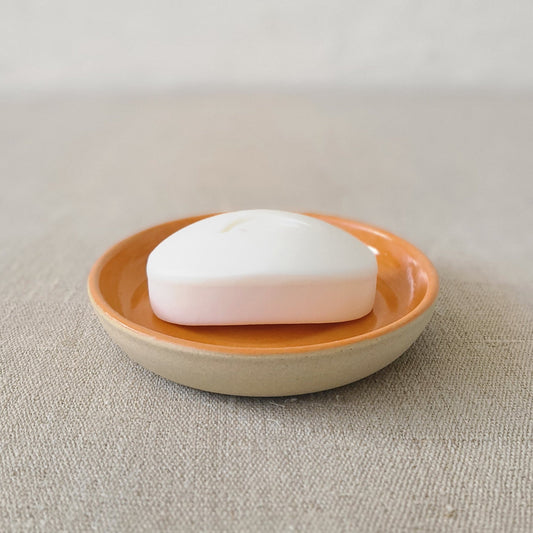 Mandarin orange ceramic soap dish by Katie L Thompson Designs with a classic design and vibrant orange color.