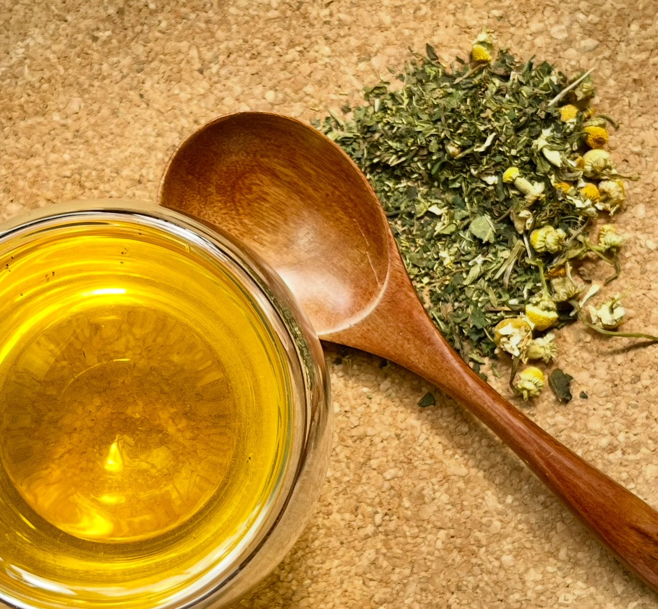 Porter Hill Tea Company Meadow Morning Walk fruit and herbal tea blend in a teacup with fresh herbs and fruits.