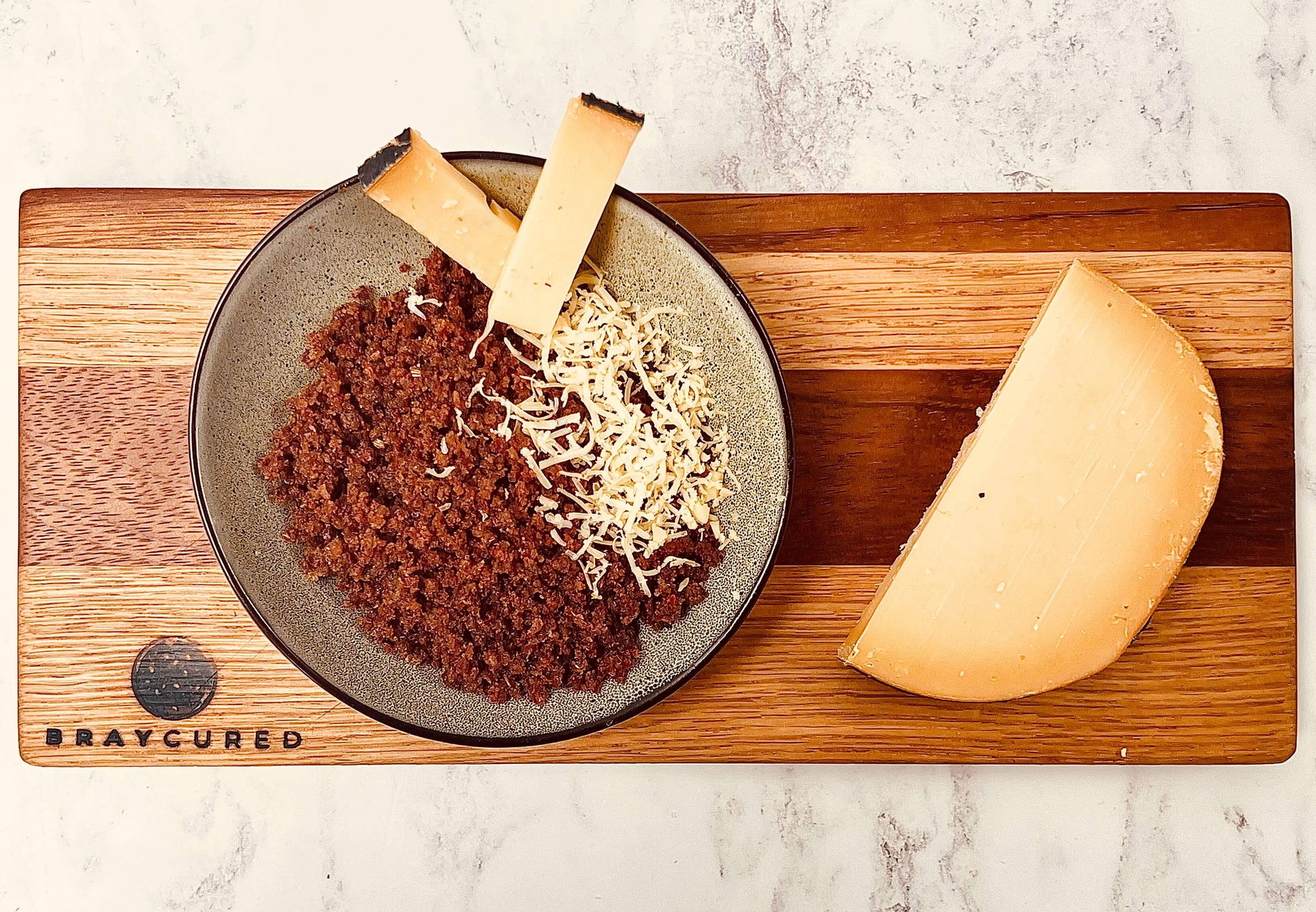 Bray Cured Meateors charcuterie with assorted cured meats and cheese on a wooden serving board.