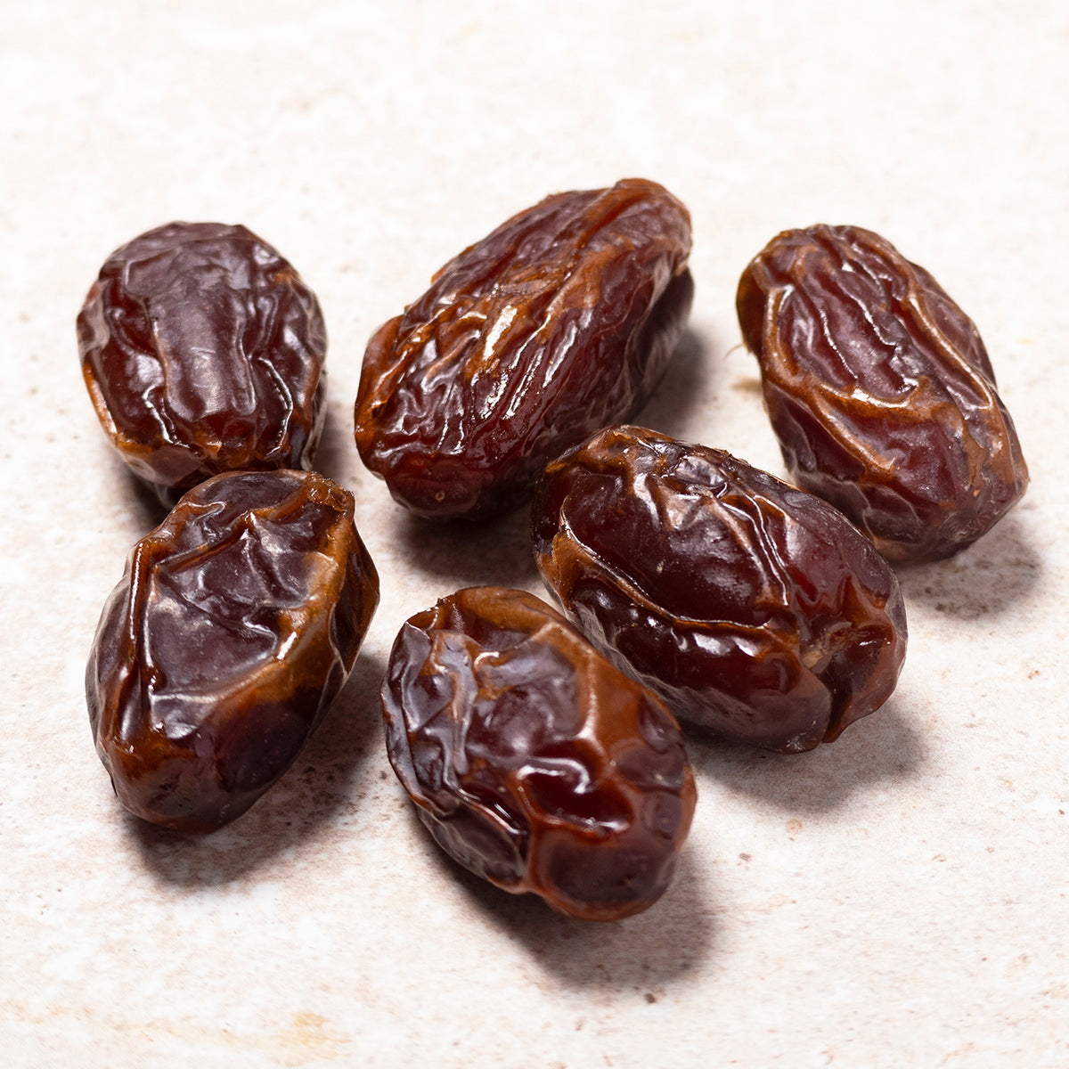 Medjoul dates, Whole Food Earth dried fruit, showing large, glossy, sweet Medjool dates with textured skin in a close-up image.