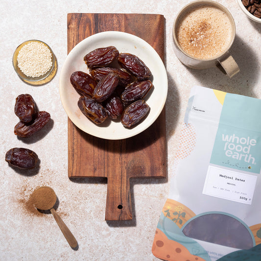 Medjoul dates from Whole Food Earth displayed in a bowl, showcasing their large, glossy, rich brown dried fruit appearance.