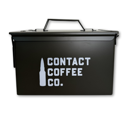 Metal coffee ammo box gear by Contact Coffee Company Ltd., compact metal tin with military-style design for storing coffee accessories.