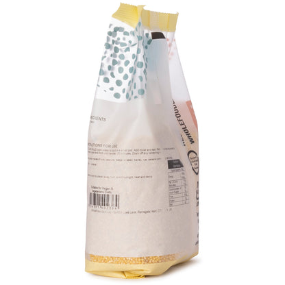 Whole Food Earth millet grain in a 500g package, showcasing small, round, yellowish millet seeds on a white background.