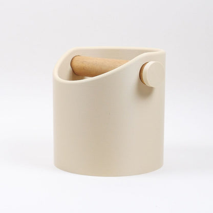 KNOCDIC® minimalist coffee knock box with a desert tan finish and real oak wood bar, used for espresso puck disposal.