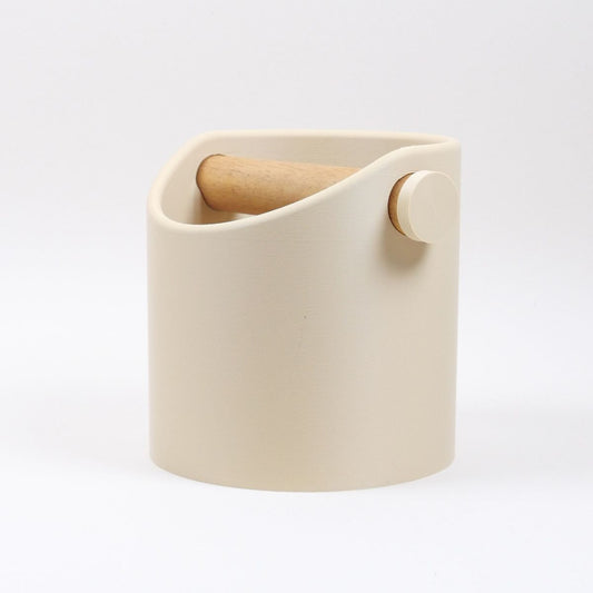 KNOCDIC® minimalist coffee knock box with a desert tan finish and real oak wood bar, used for espresso puck disposal.