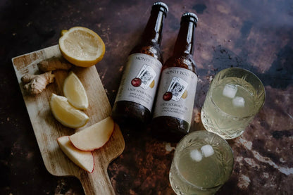 Monty Booch Lady Sourmouth kombucha bottles with apple, ginger, and lemon flavor, 330ml each in a 12-pack, unfiltered and raw.