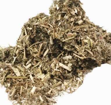 A jar of Porter Hill Tea Company's Mugwort Herbal Tea with fresh dried mugwort leaves and tea packaging on a wooden surface.