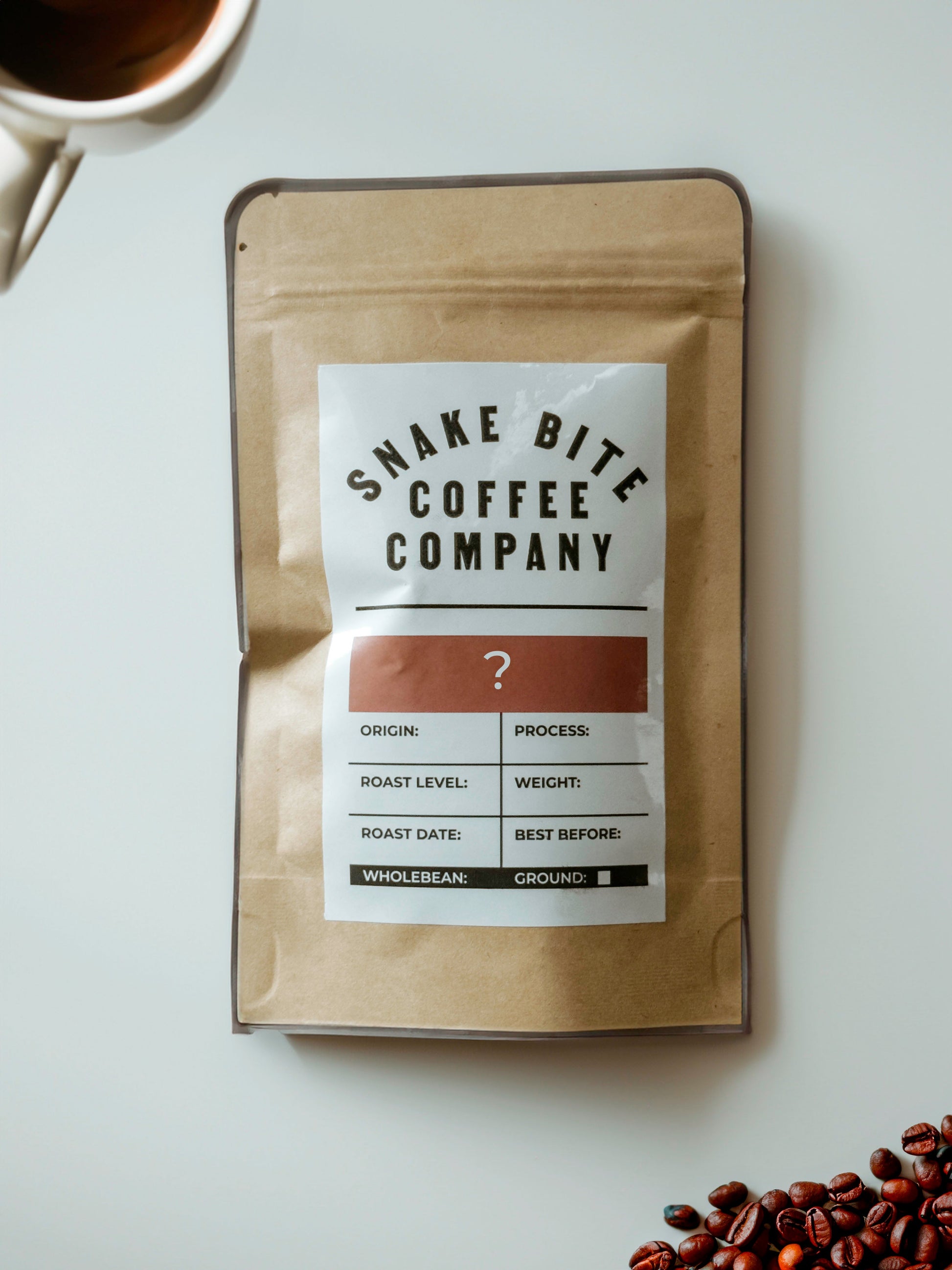 A 50g bag of Snake Bite Coffee's Explorers Delight Mystery Coffee, showcasing dark roasted coffee beans in a resealable bag.