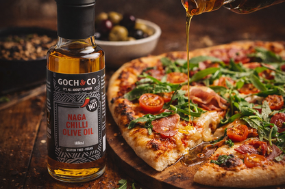 Chilli Olive Oil drizzling over a freshly baked sliced pizza on a wooden board