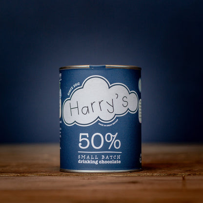 A square package of Harry's Hot Chocolate with 50% hot chocolate mix, featuring a sleek design and branding on the front.