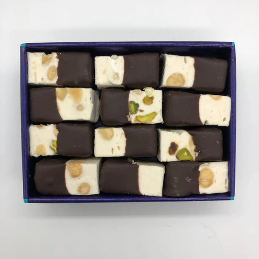 Assorted Gorvett & Stone Nougat Neapolitans with layered flavors and colorful packaging on display.