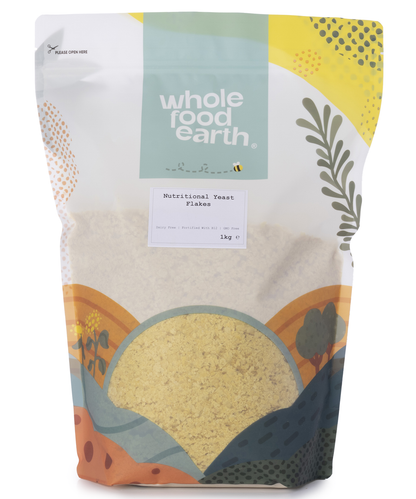 A 1kg bag of Whole Food Earth Nutritional Yeast Flakes (Nooch with B12) in a clear plastic package, showing yellow flaky flakes inside.