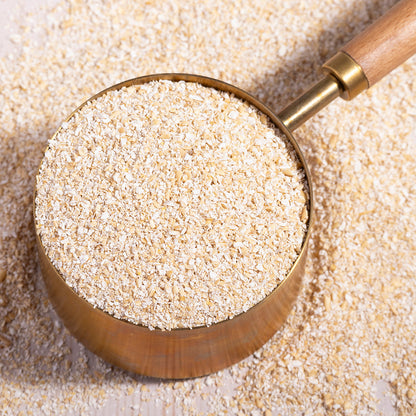 Whole Food Earth oat bran cereal in a bowl, showing its light brown, textured flakes and packaging.