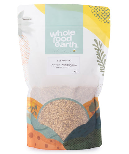 Whole Food Earth oat groats in a clear 1kg package, showing the whole, unprocessed oat grains ready for cooking or baking.