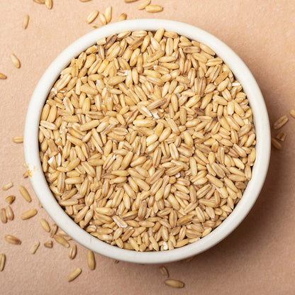 Whole Food Earth oat groats, large whole oats in a bowl, showing their natural, unprocessed grain texture for healthy breakfast cooking.