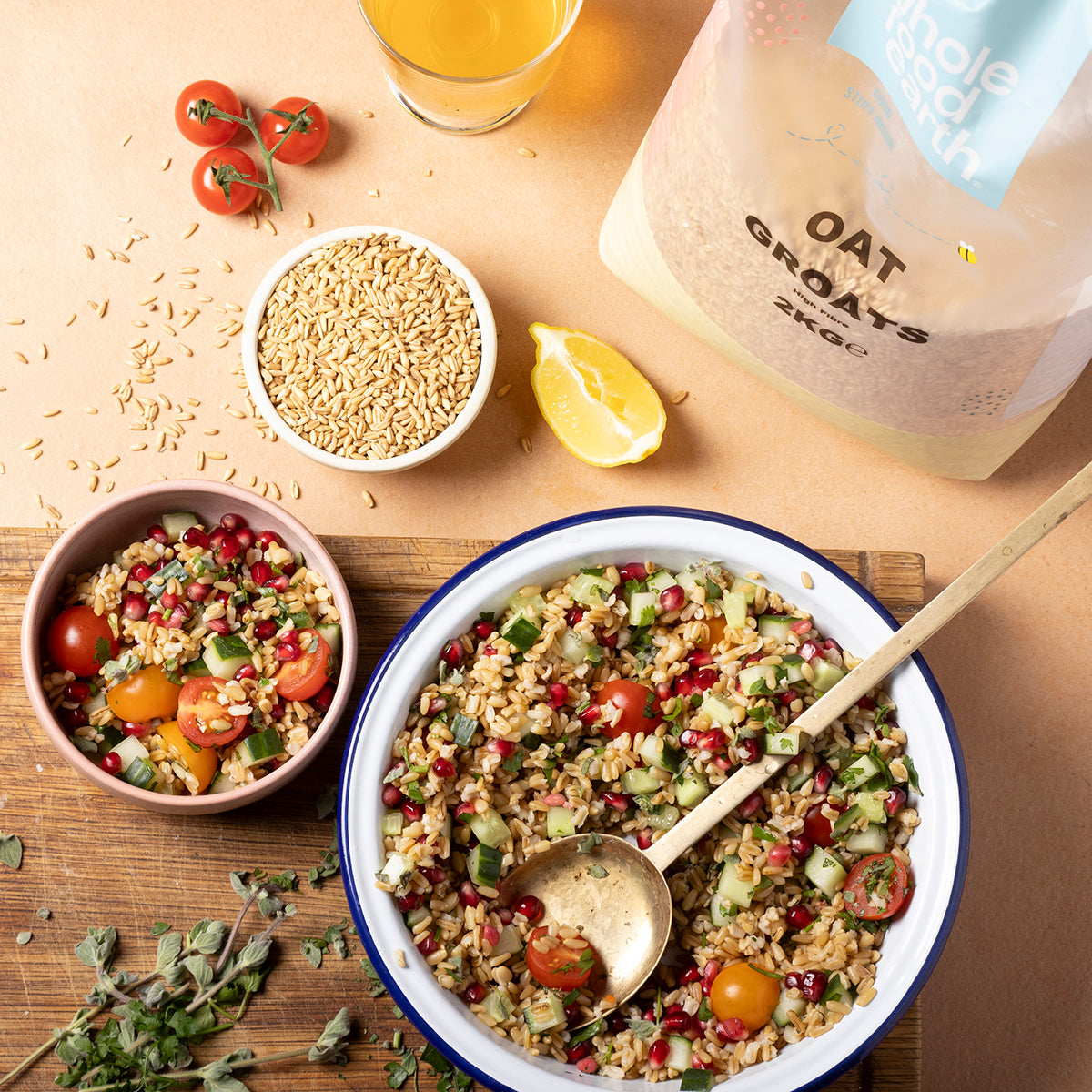 Whole Food Earth oat groats, whole oats in a bowl with scoop and spoon, ready for cooking or baking, in a natural kitchen setting.