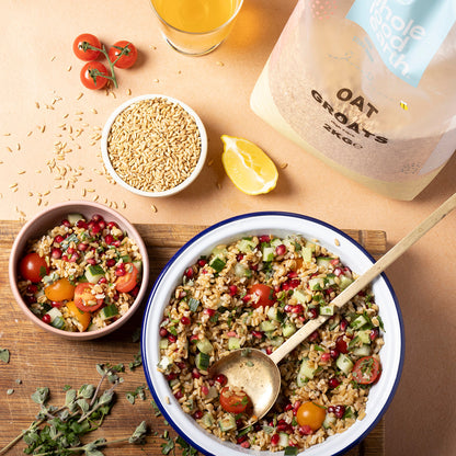Whole Food Earth oat groats, whole oats in a bowl with scoop and spoon, ready for cooking or baking, in a natural kitchen setting.