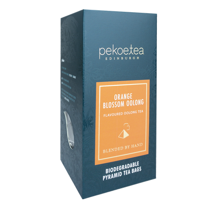 Fresh orange blossom oolong tea leaves from PekoeTea Edinburgh, showcasing vibrant orange blossoms and rolled tea leaves.