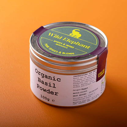 Organic basil powder in a jar from Whole Food Earth, showcasing fresh green herb with a natural, earthy appearance.
