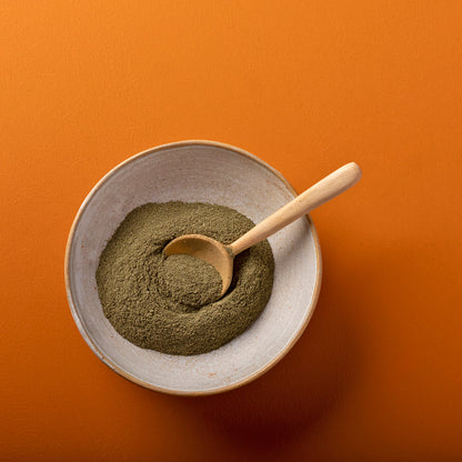 Organic basil powder from Whole Food Earth, 100g, in a clear jar, showcasing vibrant green herbal spice for cooking and seasoning.