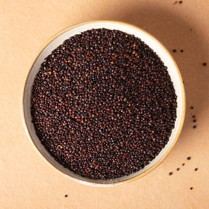 Organic black quinoa grains from Whole Food Earth, close-up of raw, organic black quinoa seeds in a bowl.