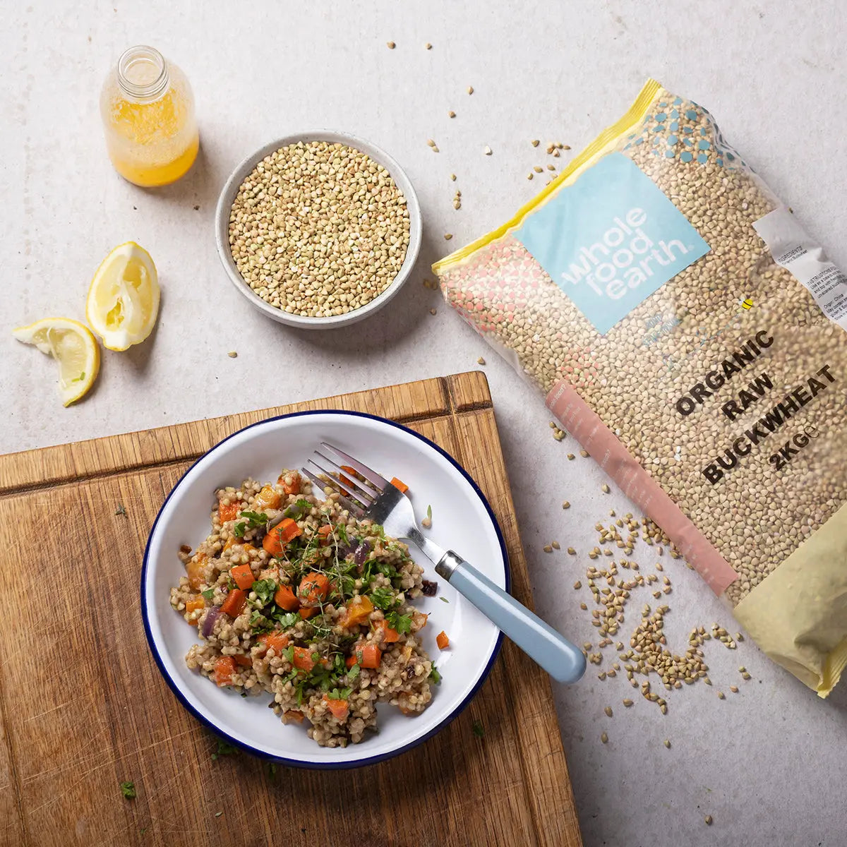 Organic Buckwheat grains from Whole Food Earth, displayed in a natural kitchen setting with a bowl and spoon.