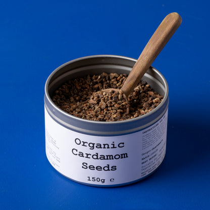 Organic cardamom seeds from Whole Food Earth, wild-harvested herbs and spices, shown in a 150g package.