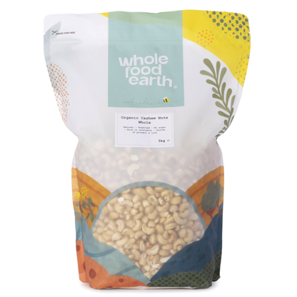 Whole Food Earth organic whole cashew nuts in a clear container, showcasing their creamy, curved appearance and natural light color.