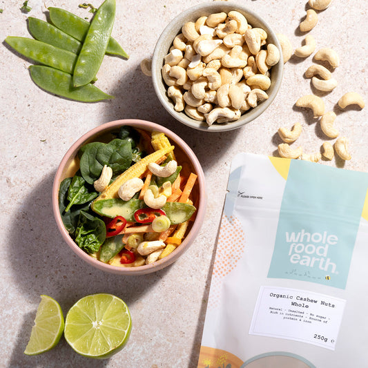 Raw organic whole cashew nuts from Whole Food Earth, displayed in a natural lifestyle setting, highlighting their creamy texture.