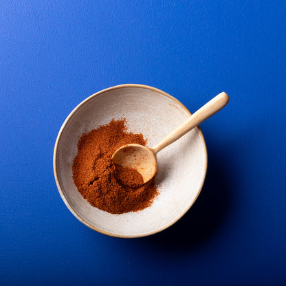 Organic cayenne pepper powder in a jar, Wild Elephant brand, highlighting vibrant red spice from Whole Food Earth herbs and spices.
