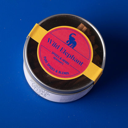 Organic cinnamon cassia sticks from Wild Elephant, 100g, in a clear jar, showcasing the aromatic, curled cinnamon bark for culinary use.