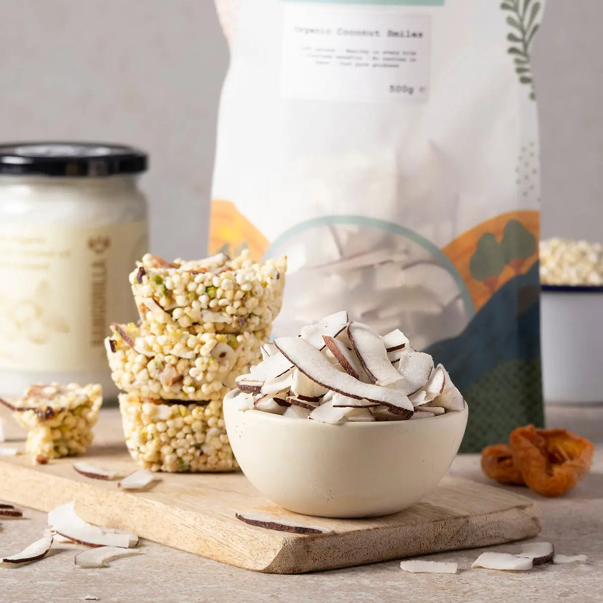 Organic Coconut Smiles dried fruit by Whole Food Earth, showcasing golden, shredded coconut pieces on a rustic wooden surface.